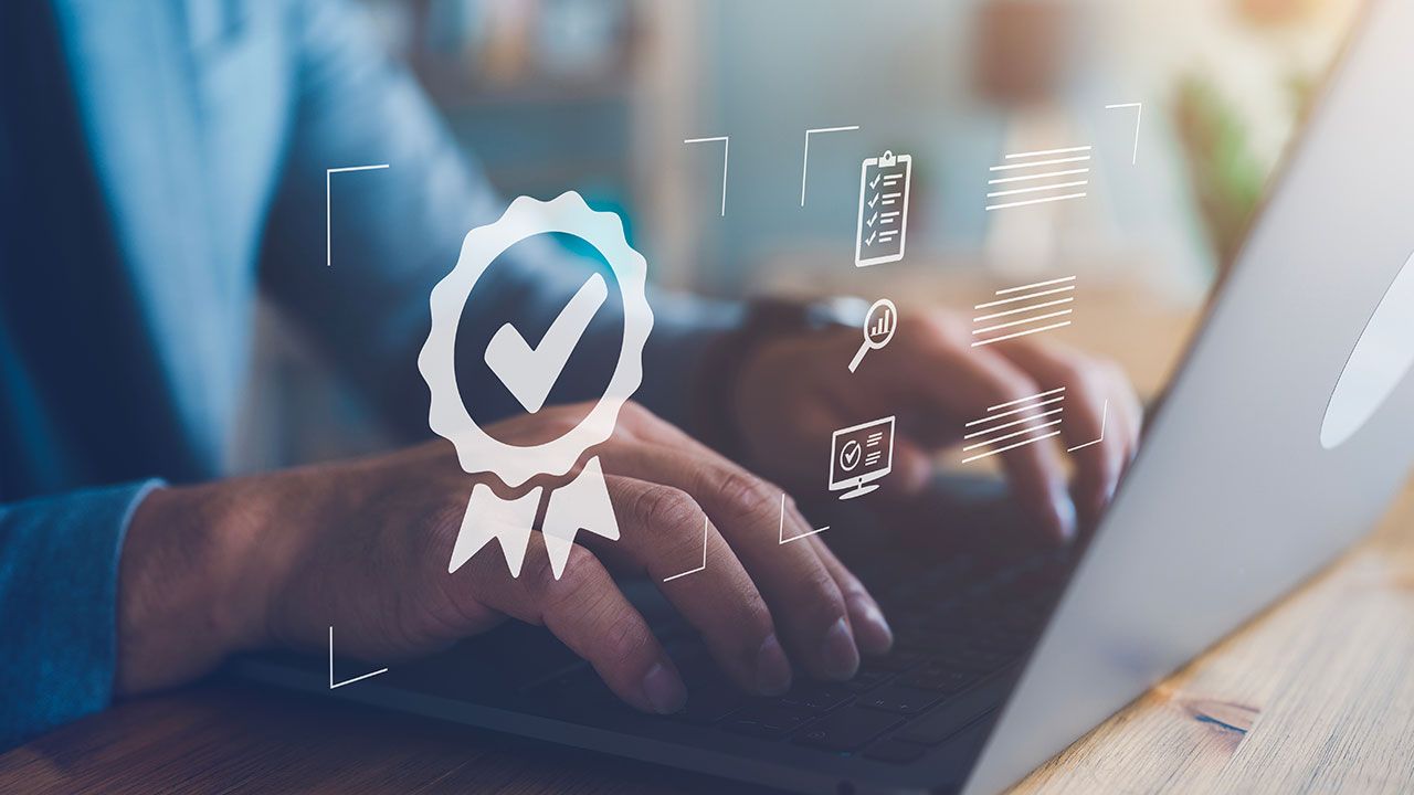 businessman working with sign of the top service Quality assurance, Guarantee, Standards, ISO certification and standardization concept. | Image Credit: ©Looker_Studio– stock.adobe.com