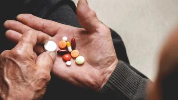 Many multi-colored pills in a Senior's hands. Painful old age. Caring for the health of the elderly | Image Credit: ©perfectlab - stock.adobe.com
