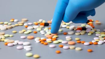 A hand in a blue glove selects pills on a gray background. The concept of the problem of correct choice in the variety of different medicines | Image Credit: © Aleksandr - © Aleksandr - Stock.adobe.com