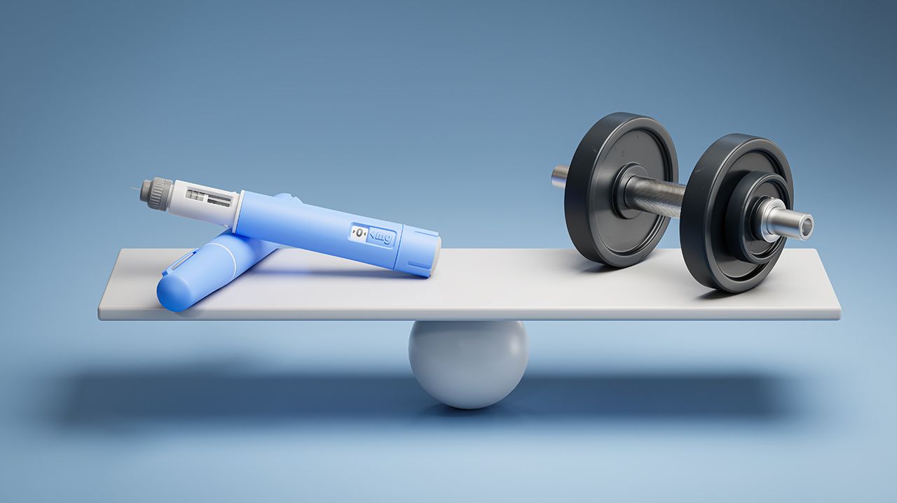 Two dosing pens of a fictitious semaglutide drug (GLP-1) on a scale facing a dumbbell. Concept for alternative ways to loose weight. | Image Credit: © Andreas Prott - Stock.adobe.com