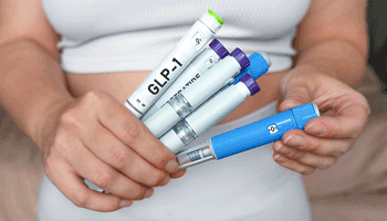 Woman holding multiple GLP-1 injection pens, weight loss and diabetes treatment concept | Image Credit: ©Kateryna -stock.adobe.com