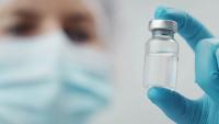Cropped shot of doctor holding transparent glass medical vial in hand, focus on bottle | Image Credit: ©MYDAYcontent - stock.adobe.com