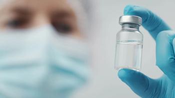 Cropped shot of doctor holding transparent glass medical vial in hand, focus on bottle | Image Credit: ©MYDAYcontent - stock.adobe.com