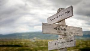 governance risk compliance text on wooden signpost outdoors in landscape scenery. | Image Credit: © Jon Anders Wiken - stock.adobe.com
