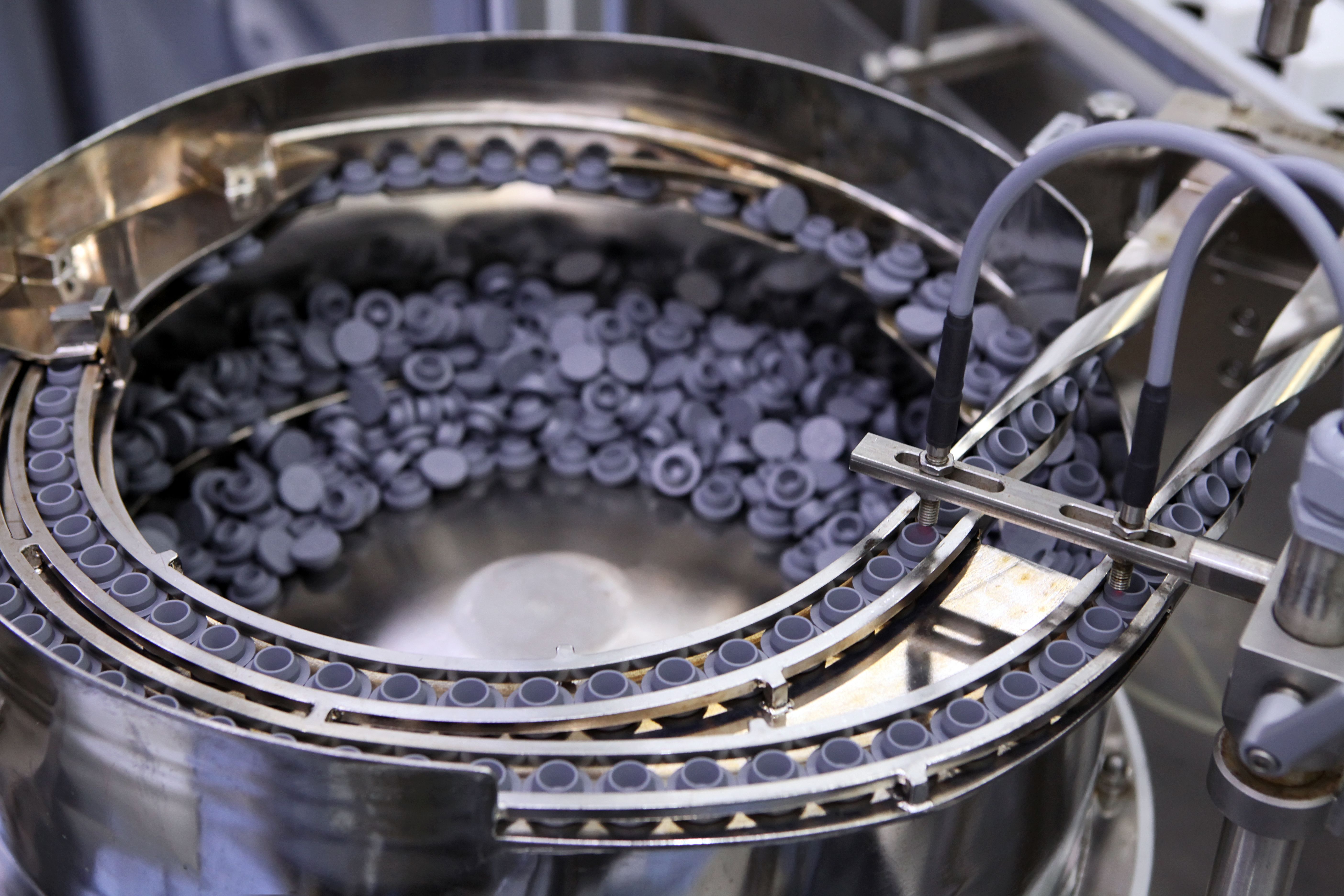 Sterile capsules for injection. Bottles on the bottling line of the pharmaceutical plant. Machine after checking sterile liquids. Interferon, nasoferon. | Image Credit: © neznamov1984 - stock.adobe.com