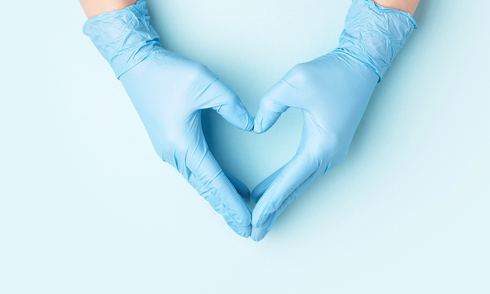 hands in gloves in heart formation