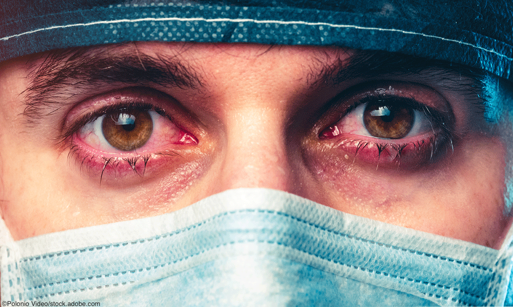 burned out Physicain wearing mask and scrubs