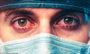 burned out Physicain wearing mask and scrubs