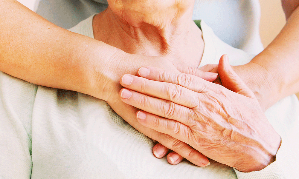 doctor hugging elderly patient