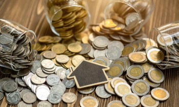 house icon over gold and silver coins