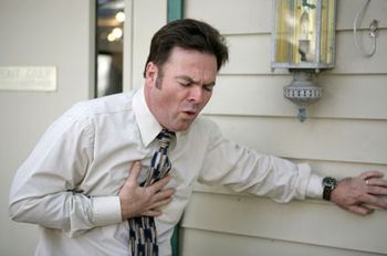 Older man having a heart attack.