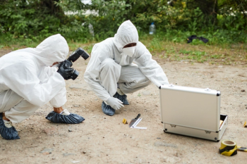 Two people wearing protective suits working at crime scene evaluating evidence © Seventyfour -chronicles-stock.adobe.com