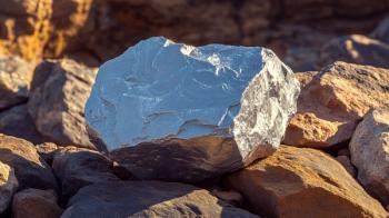 Closeup of shiny nickel mineral ore in rough round shape with silver color, capturing the texture and shine with blurred background, blank space on the side for caption or design elements. Generated with AI. | Image Credit: © Your Hand Please - stock.adobe.com