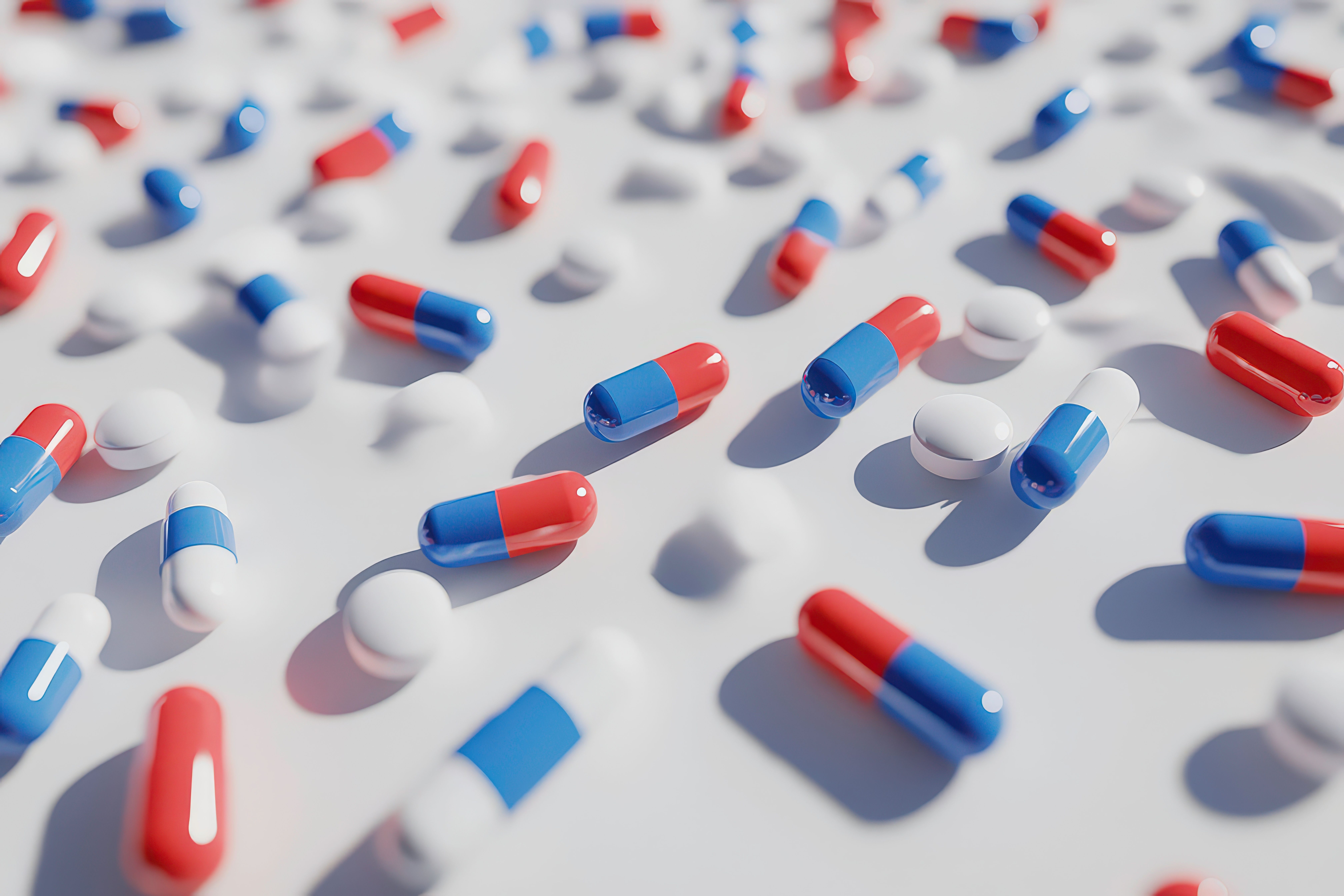 A collection of colorful capsules and tablets scattered on a surface. Generated by AI. | Image Credit: © Khatyjay - stock.adobe.com