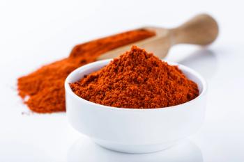Fragrant ground paprika on a white acrylic background | Image Credit: © Narsil - stock.adobe.com