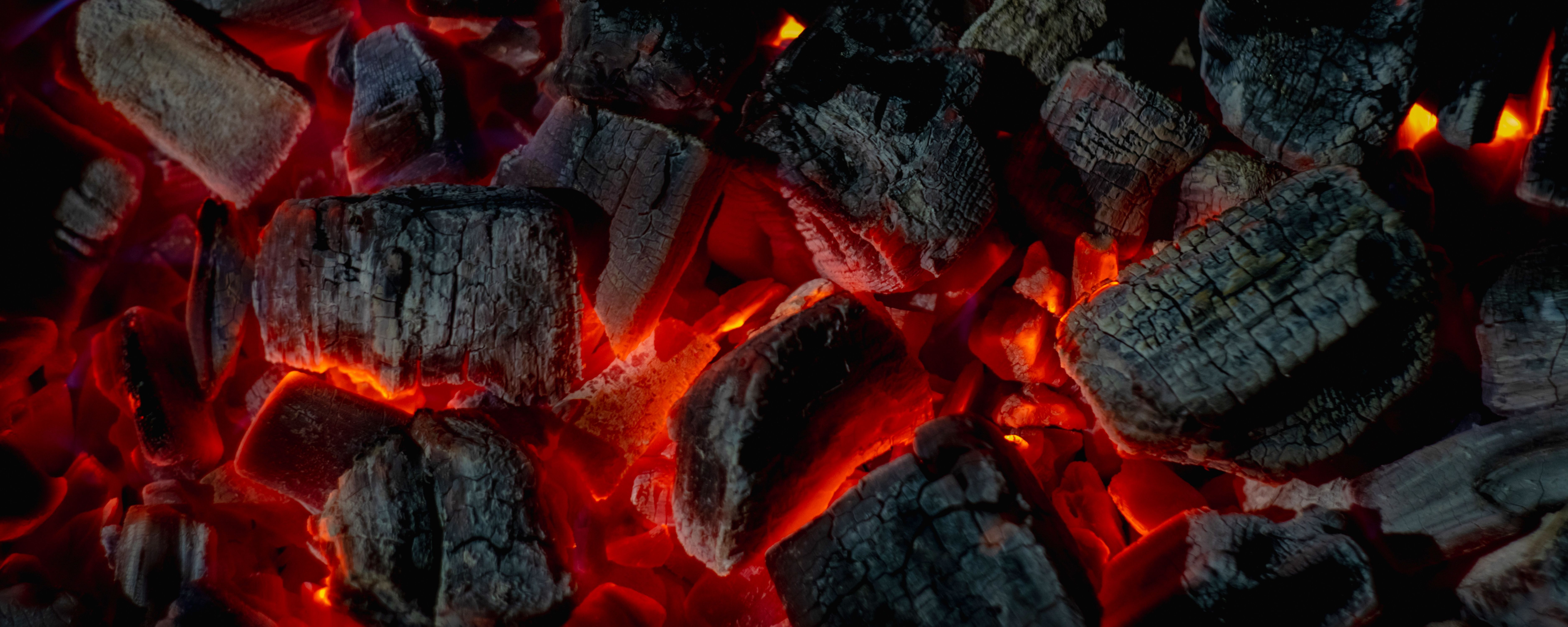 hot red coals among black ash, wallpapers for mobile devices, abstract | Image Credit: © Dmitriy Popov - stock.adobe.com