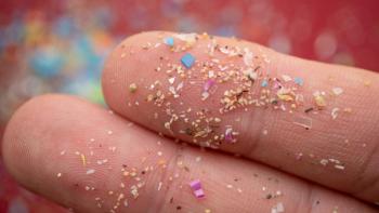 Microplastic particles on a human finger for scale. Concept for water pollution and global warming. Macro shot on a bunch of microplastics that cannot be recycled. | Image Credit: © SIV Stock Studio - stock.adobe.com