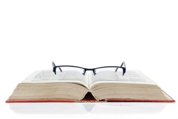 book open with glasses laying on top