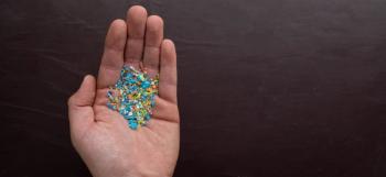 Close-up of micro plastic particles in a person's hand. The concept for water pollution and global warming. Macro shot on a bunch of microplastics that cannot be recycled. | Image Credit: © SIV Stock Studio - stock.adobe.com