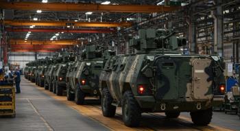 A line of military vehicles ready for action, showcasing modern armored technology and heavy machinery in an industrial setting. Generated with AI. | Image Credit: © GS-Studio - stock.adobe.com
