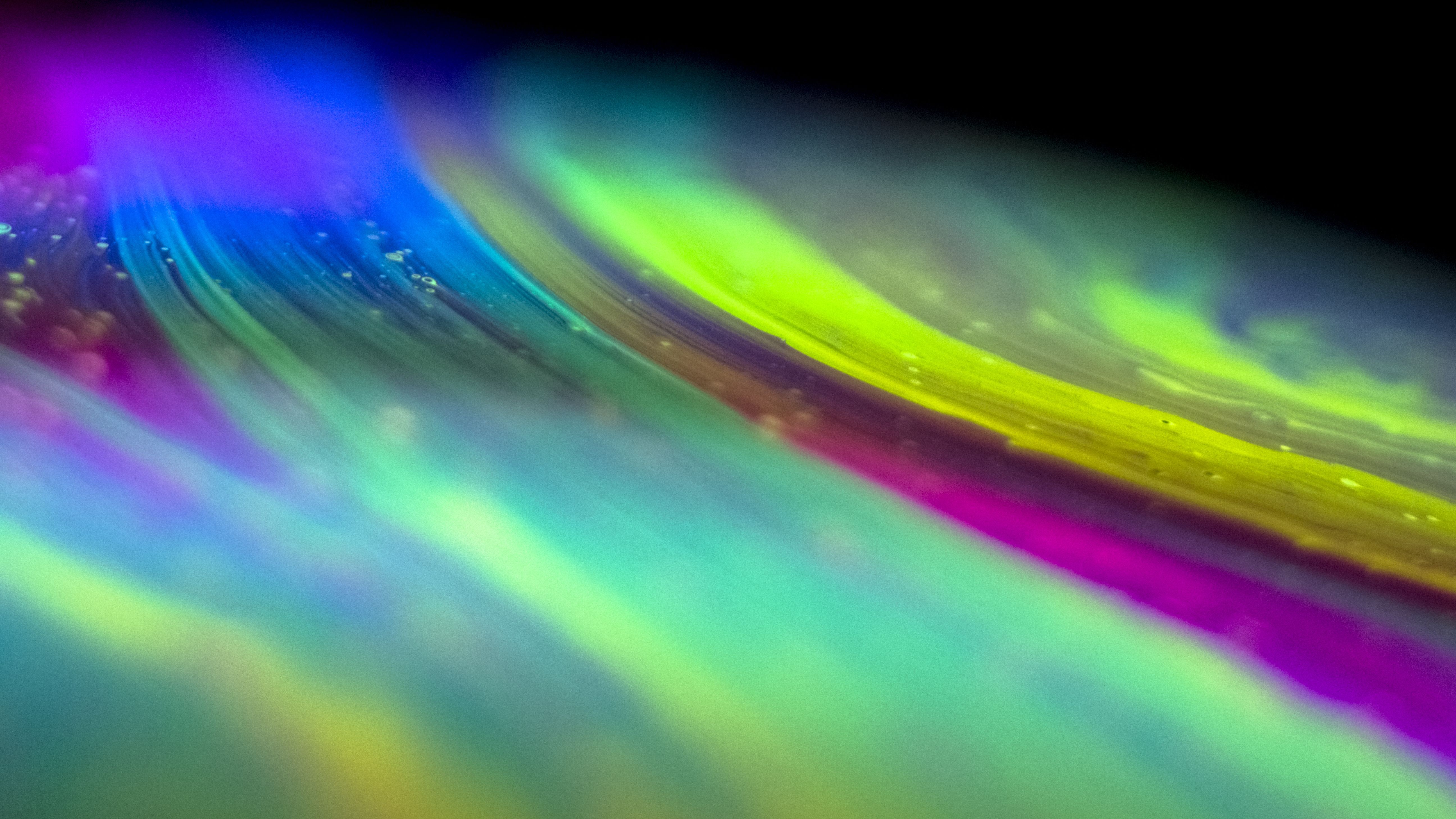 spectrum of bright greenish and purplish colors.