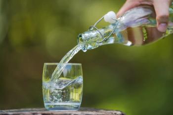 Hand pouring drink water from bottle into glass with natural background | Image Credit: © Naypong Studio - stock.adobe.com
