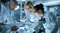 Team of Medical Research Scientists Work on a New Generation Disease Cure. They use Microscope, Test Tubes, Data Implementing Technology. Laboratory Looks Busy, Bright and Modern. | Image Credit:  Gorodenkoff - stock.adobe.com