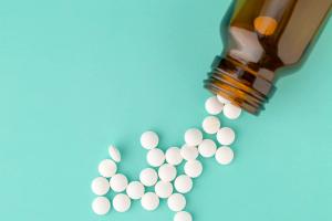 aspirin pills spilling out of a bottle