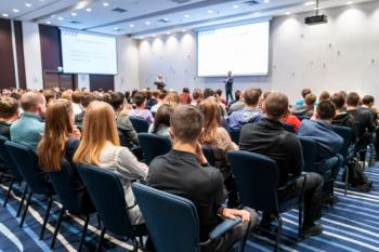 Image of a conference that takes place in a large conference room, workshop for young professionals, training in a large conference room, adult training | Image Credit: © borisblik - stock.adobe.com