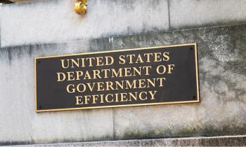 Golden sign outside the United States Department of Government Efficiency (DOGE) © stockyme -chronicles-stock.adobe.com