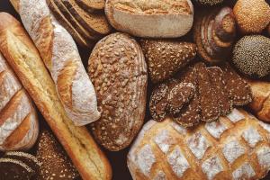 Bread background, top view of white, black and rye loaves | Image Credit: © Prostock-studio - stock.adobe.com