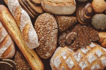 Bread background, top view of white, black and rye loaves | Image Credit: © Prostock-studio - stock.adobe.com
