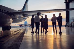 Unrecognizable people standing near the aircraft in the aviation hangar | Image Credit: © Svitlana - stock.adobe.com.