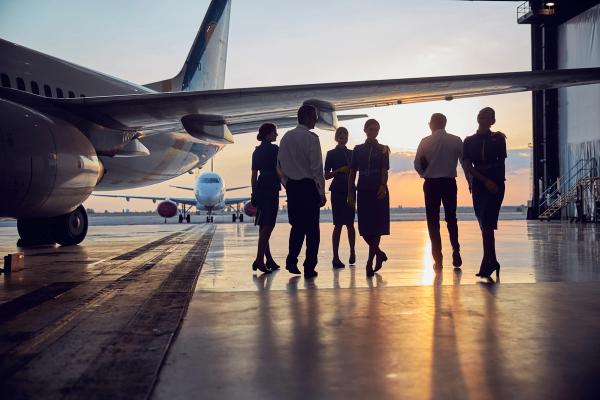 Unrecognizable people standing near the aircraft in the aviation hangar | Image Credit: © Svitlana - stock.adobe.com.