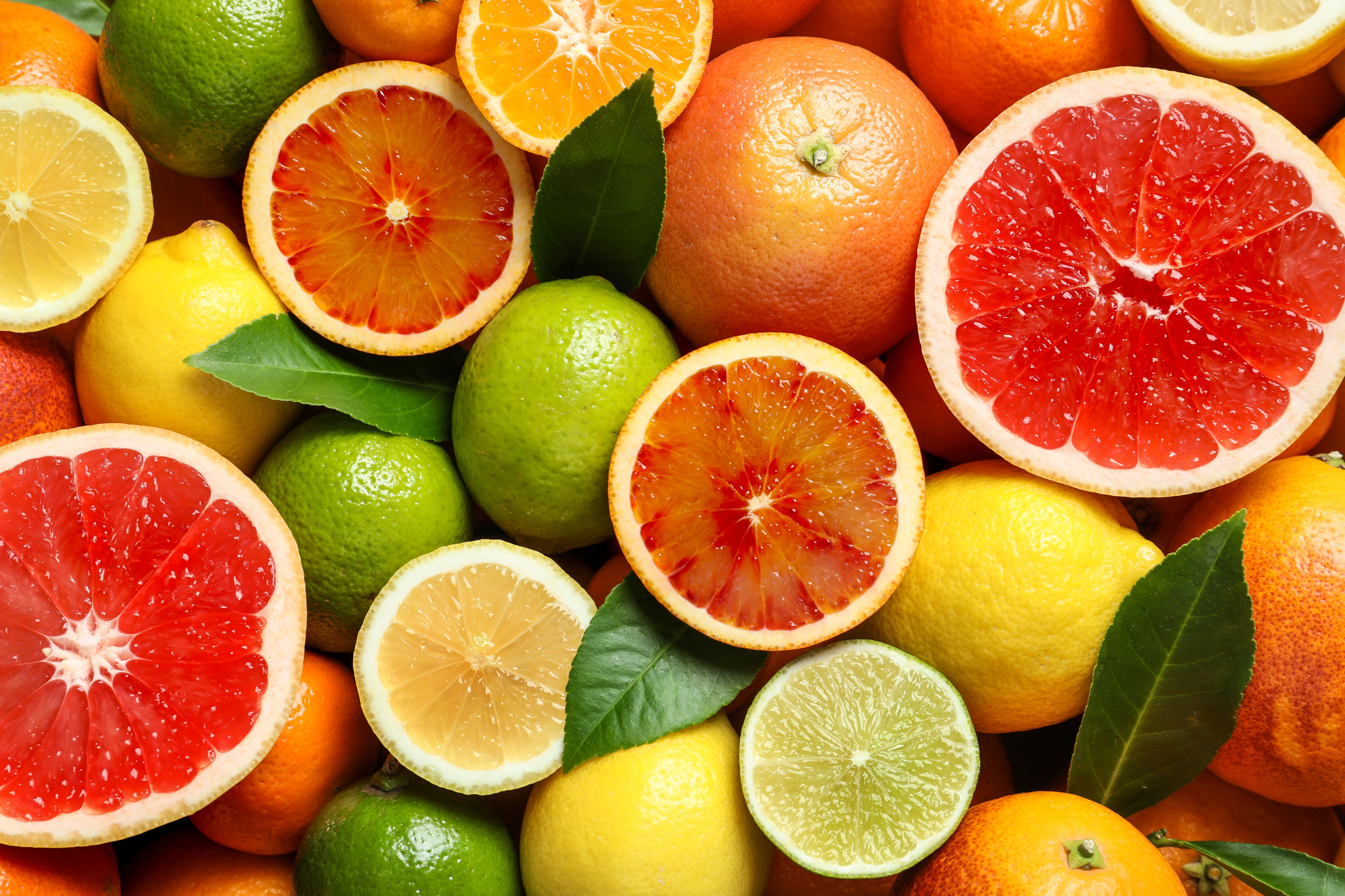 Different citrus fruits as background, top view. | Image Credit: © New Africa - stock.adobe.com