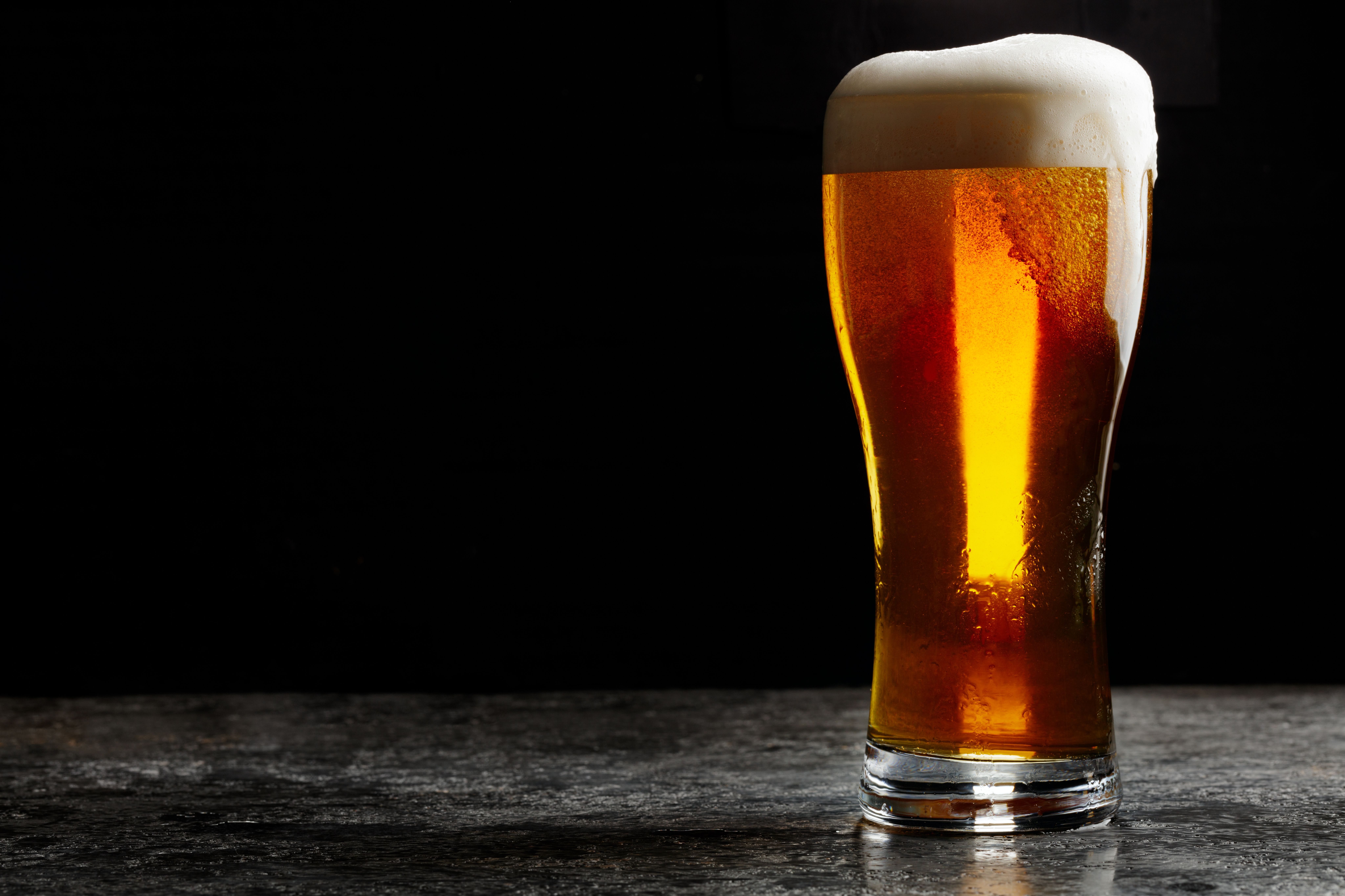 Glass of cold craft light beer on dark background. | Image Credit: © gornist - stock.adobe.com