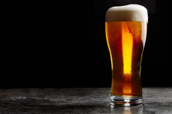 Glass of cold craft light beer on dark background. | Image Credit: © gornist - stock.adobe.com