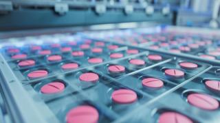 Macro Shot of Pink Pills During Production and Packing Process on Modern Pharmaceutical Factory. Medical Drug Manufacturing. | Image Credit: © IM Imagery - stock.adobe.com.
