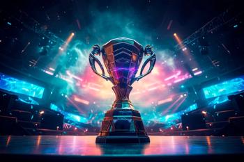 The esports winner trophy standing on the stage in the middle of the arena of the computer video game championship. Two rows of PCs for competing teams. Stylish neon lights with a cool design. | Image Credit: © Александр Марченко - stock.adobe.com. 