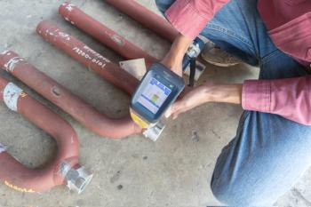 Worker inspect metal components of steel pipes with a portable XRF analyzer. Portable instrumentation is making numerous strides in many application areas. | Image Credit: © Chaimongkol - stock.adobe.com