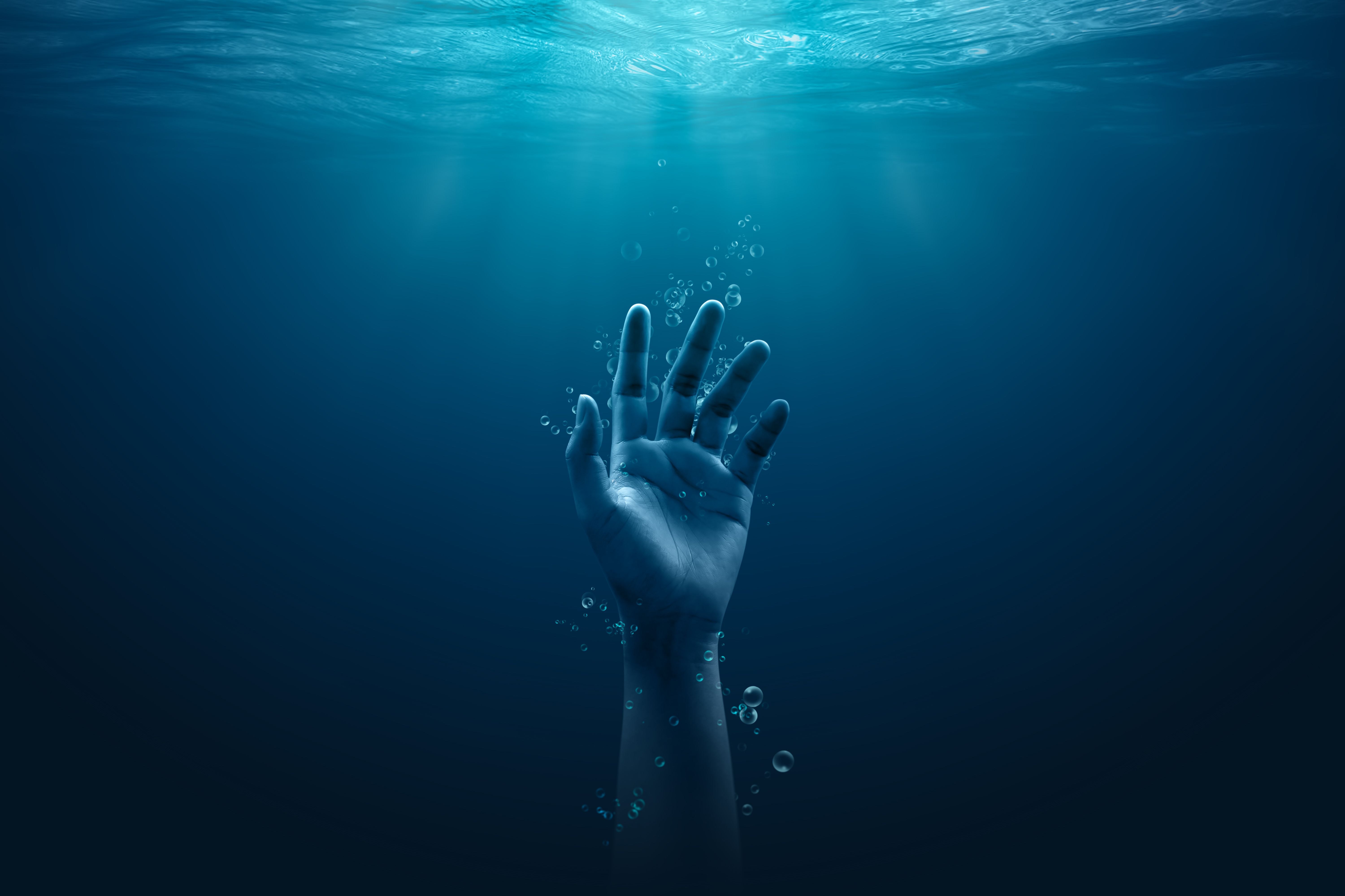 Despair drowning hand underwater danger help accident on urgency sos dangerous water background of emergency problem rescue ocean swimming warning risk or saving life reaching hopeless alone concept. | Image Credit: © Lemonsoup14 - stock.adobe.com