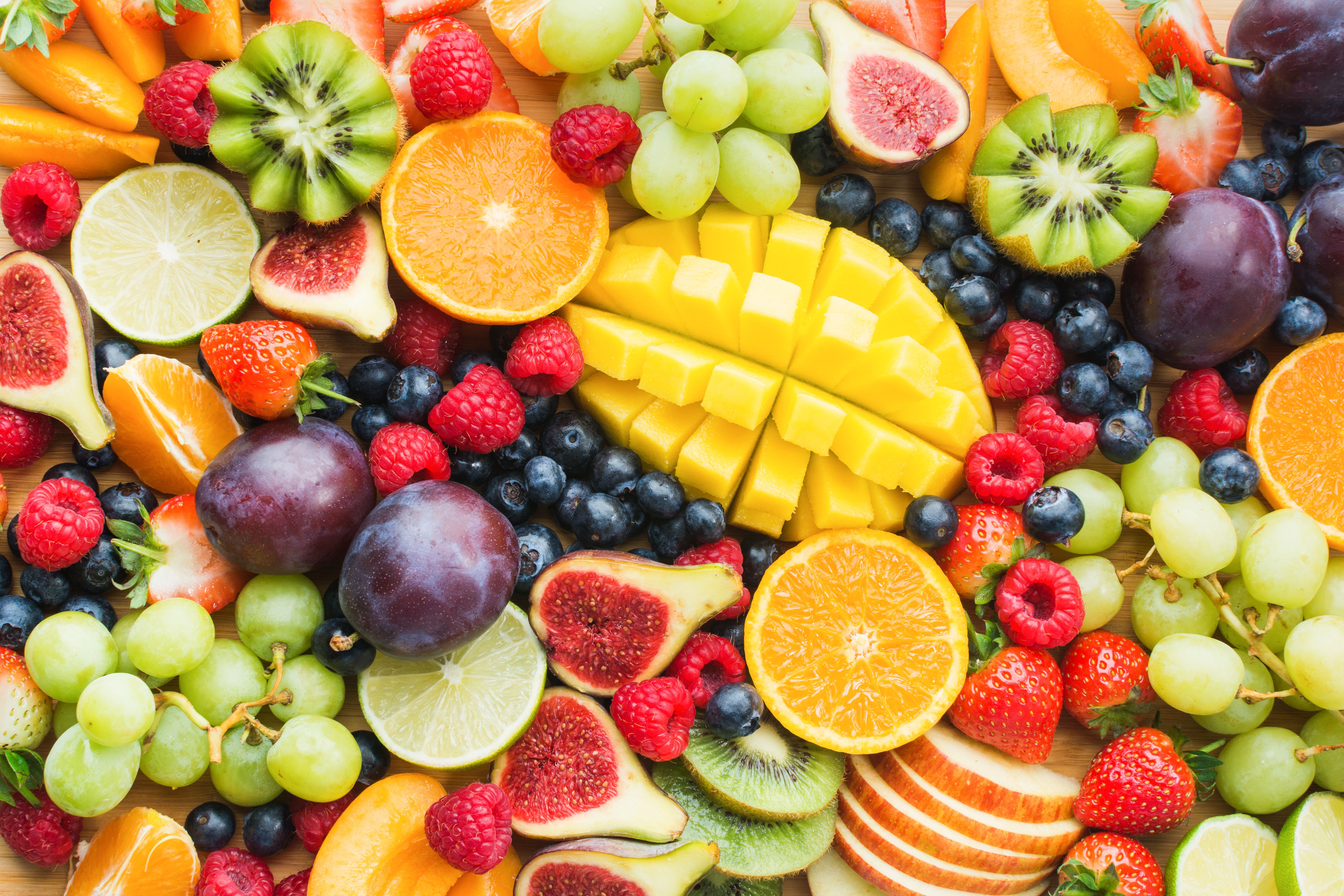 Assortment of healthy raw fruits and berries platter background, strawberries raspberries oranges plums apples kiwis grapes blueberries, mango, top view, selective focus | Image Credit: © Liliya Trott - stock.adobe.com. 