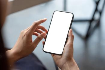Close-up of a businessman hand holding a smartphone white screen is blank the background is blurred. | Image Credit: © amnaj - stock.adobe.com