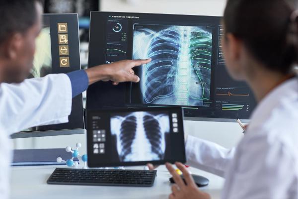 Clinical diagnosis and collaboration. Ideal for healthcare technology, radiology, and/or AI diagnostics marketing | Image Credit: © DragonImages - stock.adobe.com