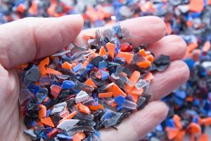 A pile of microplastics - small pieces of hard plastic on palm, intended for further processing. | Image Credit: © luckakcul - stock.adobe.com.