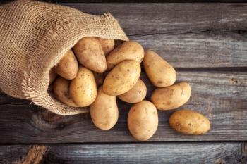 Raw potato food. Fresh potatoes in an old sack on wooden background | Image Credit: © Valentina Rychkova - stock.adobe.com