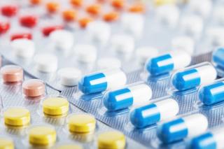 Heap of medical pills in white, blue and other colors. Pills in plastic package. Concept of healthcare and medicine. | Image Credit: okskaz - stock.adobe.com