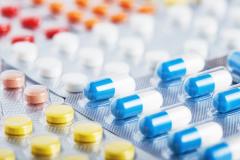 Heap of medical pills in white, blue and other colors. Pills in plastic package. Concept of healthcare and medicine. | Image Credit: okskaz - stock.adobe.com