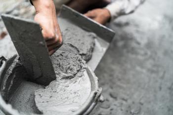 Hand worker mix cement plastering well. Themro Fisher’s new XRD platform is designed for those in the cement industry. | Image Credit: © Nature Peaceful - stock.adobe.com