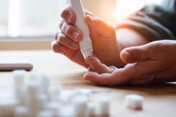 Senior woman hands using lancet on finger at home to check blood sugar level, glucometer and sugar cubes on wooden table close up, diabetes concept, elderly health care, sunny morning. | Image Credit: © zakalinka -stock.adobe.com
